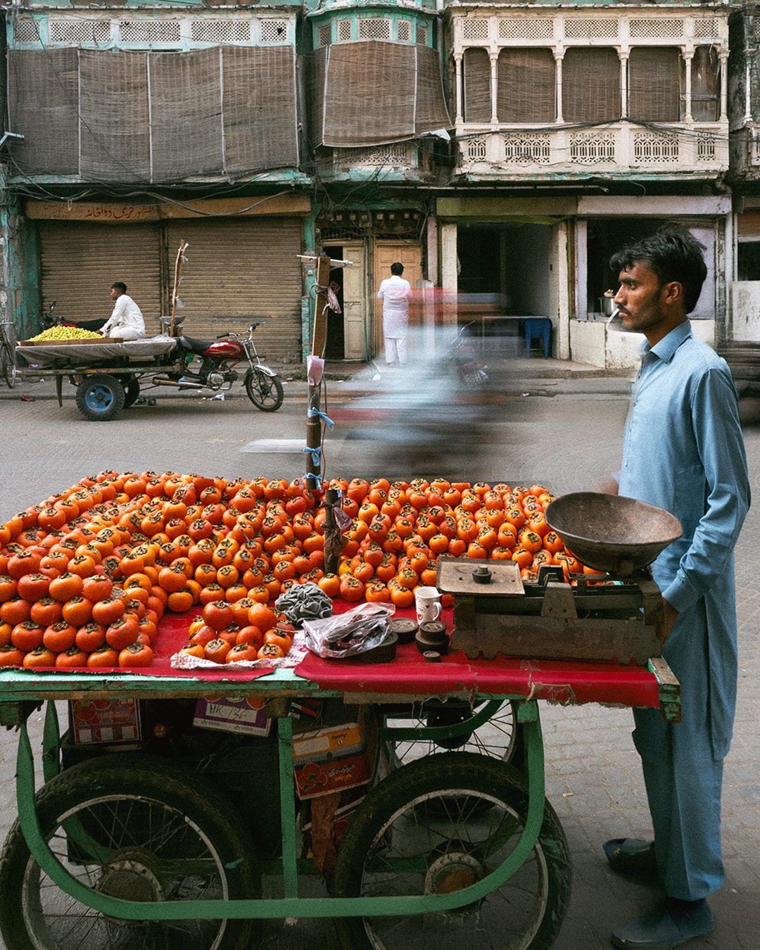 A street photograph taken in Lahore featuring three men, lost in their own separate worlds.